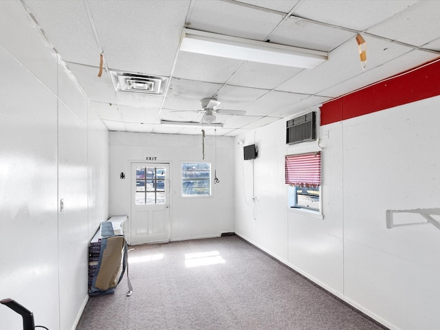 unfurnished room with ceiling fan, carpet flooring, and a paneled ceiling