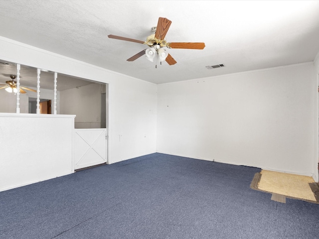 carpeted empty room with crown molding, ceiling fan, and a textured ceiling