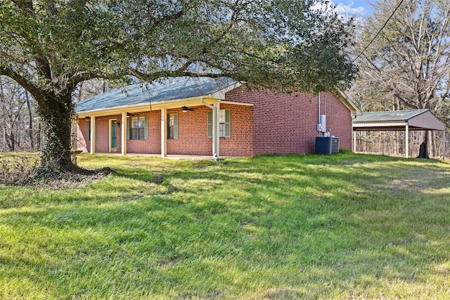 exterior space featuring central AC, ceiling fan, and a front lawn