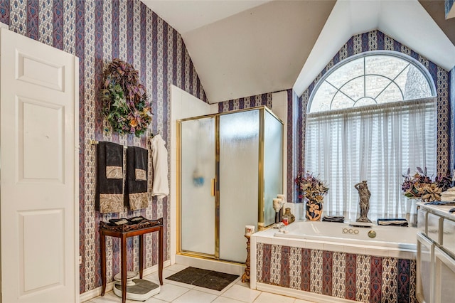 full bathroom featuring lofted ceiling, a stall shower, a garden tub, and tile patterned floors