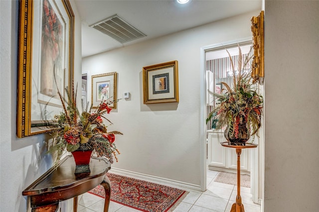 interior space featuring visible vents, baseboards, and light tile patterned floors