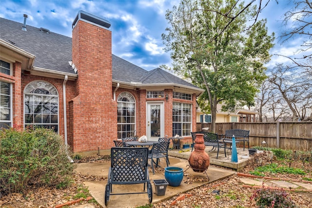 view of patio featuring outdoor dining space and fence