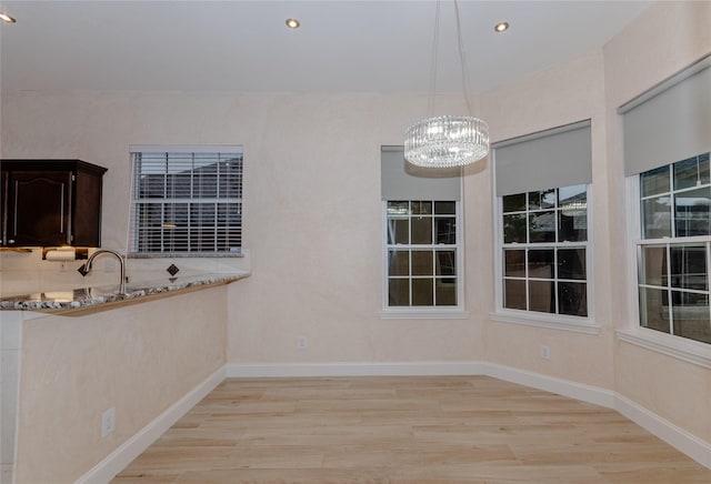 unfurnished dining area featuring light hardwood / wood-style floors