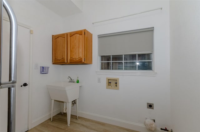 laundry area with cabinets, light wood-type flooring, electric dryer hookup, and hookup for a washing machine