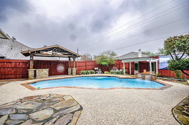 view of swimming pool featuring pool water feature, a gazebo, and a patio area