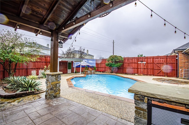 view of swimming pool with a patio and pool water feature