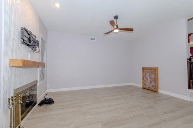 living room with light hardwood / wood-style floors and ceiling fan