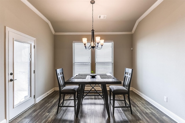 dining area with ornamental molding, dark wood-type flooring, and an inviting chandelier