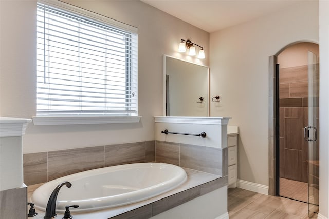 bathroom featuring independent shower and bath