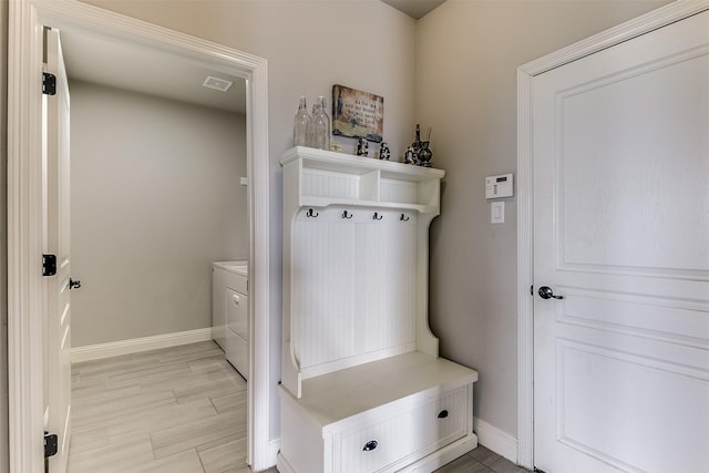 mudroom with light hardwood / wood-style floors and washer and clothes dryer