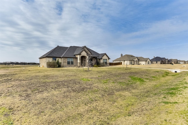 french country style house with a front yard