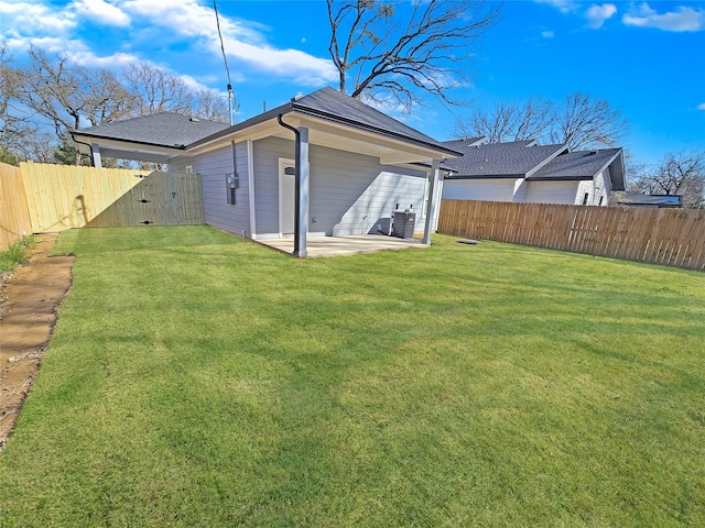 back of house with central AC unit, a patio, and a yard