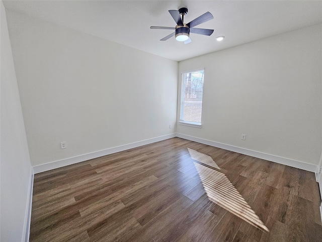 unfurnished room with dark wood-type flooring and ceiling fan