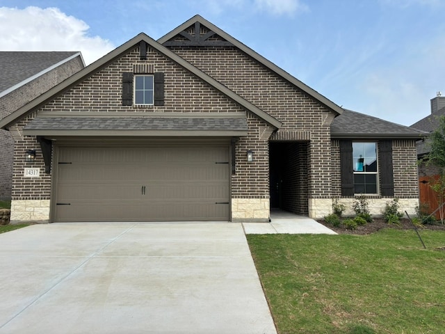 view of front of property with concrete driveway, a shingled roof, an attached garage, and brick siding