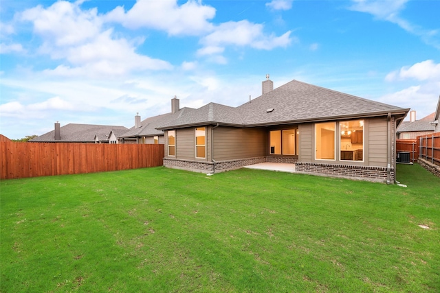 14317 Nebula Dr, Haslet, TX 76052 - rear view of house featuring brick siding, a yard, a patio, a fenced backyard, and central AC unit