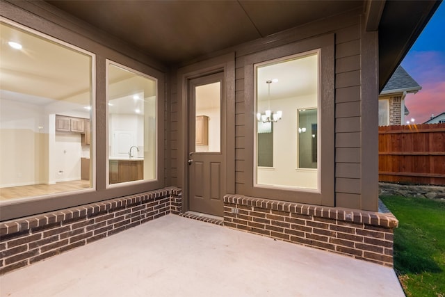 14317 Nebula Dr, Haslet, TX 76052 - view of exterior entry with a sink, fence, and a patio area