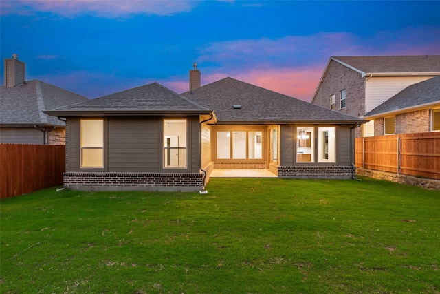 14317 Nebula Dr, Haslet, TX 76052 - back of house at dusk featuring a yard and brick siding