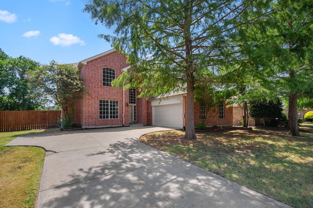 view of front of property featuring a front yard and a garage