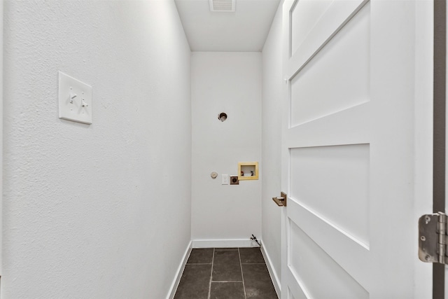 clothes washing area with laundry area, baseboards, dark tile patterned floors, washer hookup, and electric dryer hookup