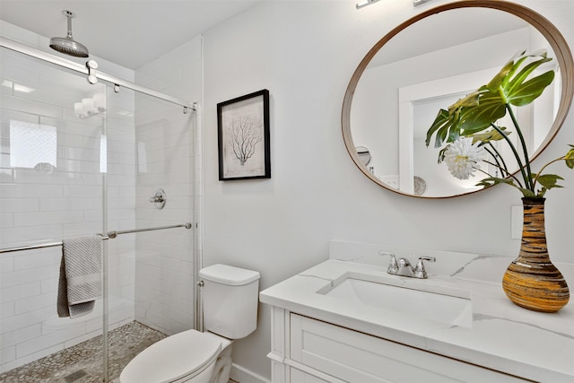 bathroom featuring a stall shower, vanity, and toilet