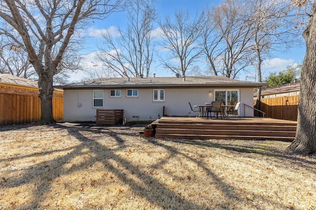 rear view of house featuring a yard, crawl space, fence, and a wooden deck