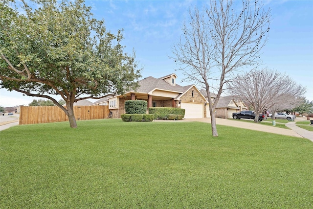 view of front of home featuring a front yard and a garage