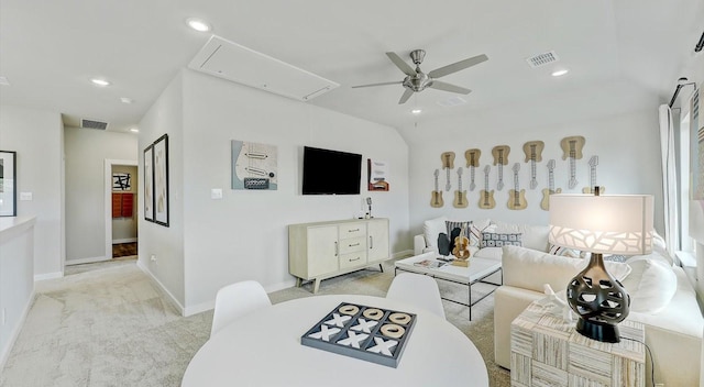 living room with lofted ceiling, light colored carpet, and ceiling fan