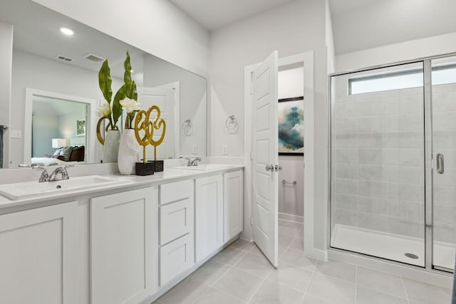 bathroom with tile patterned flooring, an enclosed shower, and vanity