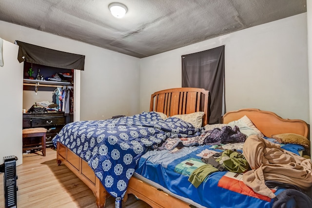 bedroom featuring light wood-type flooring and a closet