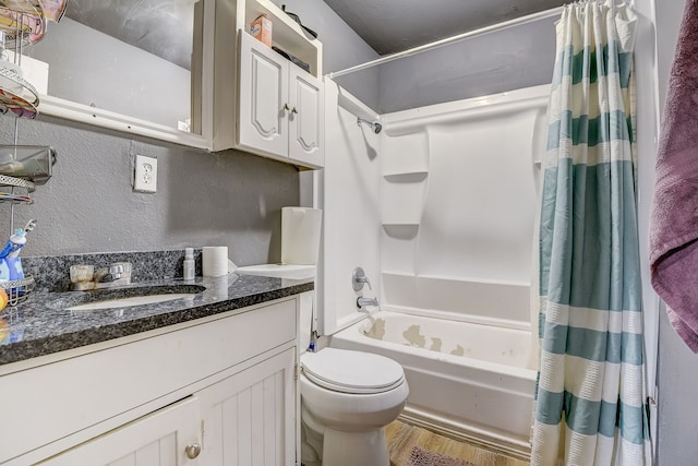 full bathroom featuring hardwood / wood-style floors, vanity, toilet, and shower / tub combo