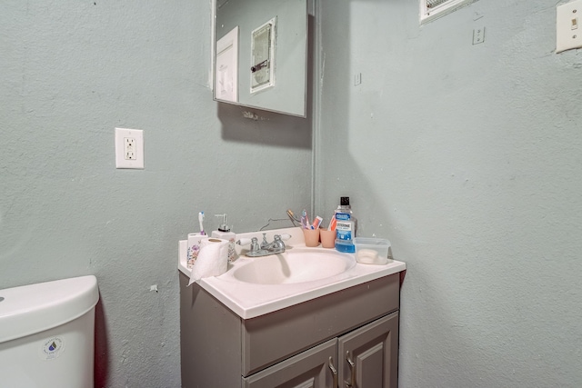 bathroom featuring vanity and toilet