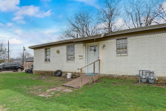 view of front facade with a front yard and brick siding