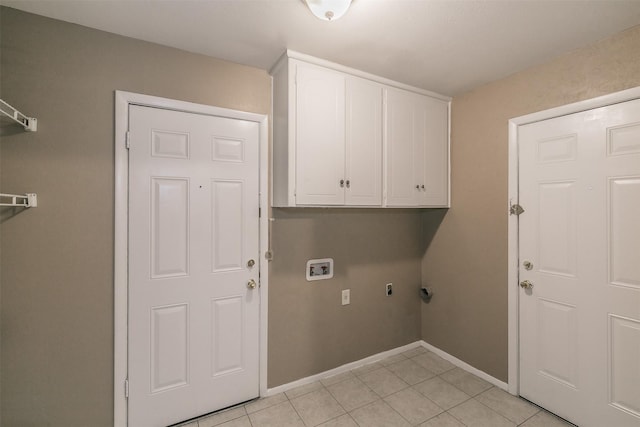 washroom with light tile patterned floors, washer hookup, cabinets, and electric dryer hookup