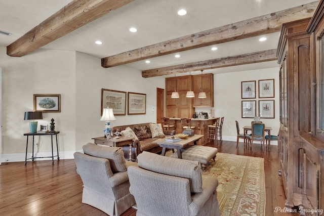 living room featuring dark wood-type flooring and beam ceiling