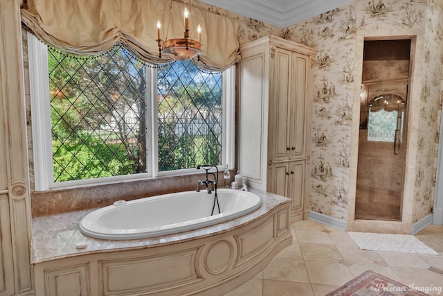 bathroom featuring a tub, tile patterned floors, an inviting chandelier, and ornamental molding