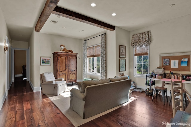 living room with a healthy amount of sunlight, beamed ceiling, and dark hardwood / wood-style floors