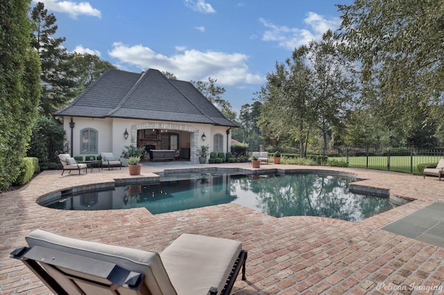 view of swimming pool featuring a patio area and an outdoor structure