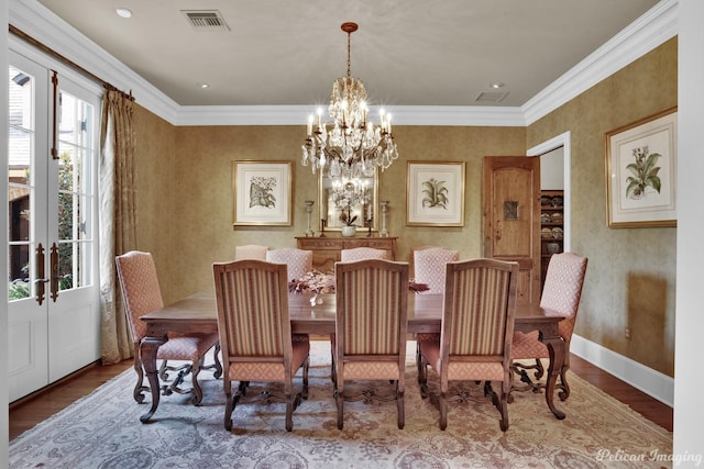 dining room with hardwood / wood-style flooring, crown molding, and a wealth of natural light