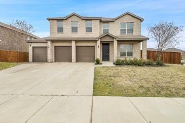 traditional-style house featuring concrete driveway, an attached garage, and fence