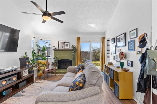 821 Dublin Dr Unit 143, Richardson, TX 75080 - living area with a fireplace with raised hearth, ceiling fan, a textured ceiling, and wood finished floors