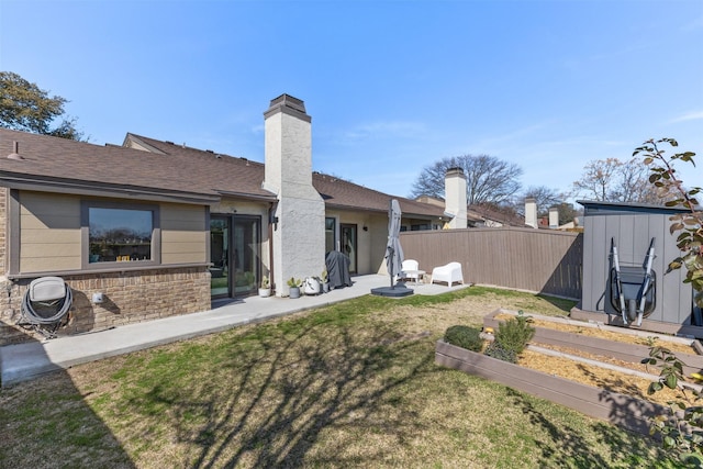821 Dublin Dr Unit 143, Richardson, TX 75080 - back of house with roof with shingles, fence, a yard, a patio, and a vegetable garden