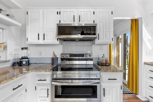 821 Dublin Dr Unit 143, Richardson, TX 75080 - kitchen with white cabinets, appliances with stainless steel finishes, and light stone counters