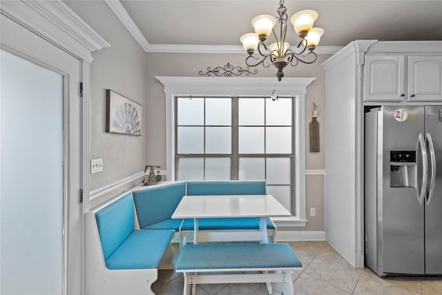 tiled dining room with an inviting chandelier, crown molding, and breakfast area