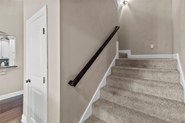 stairway with hardwood / wood-style floors