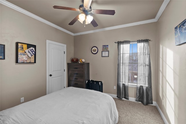 carpeted bedroom featuring ceiling fan and crown molding