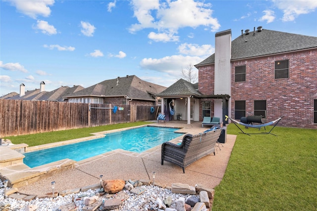 view of pool featuring a patio and a lawn