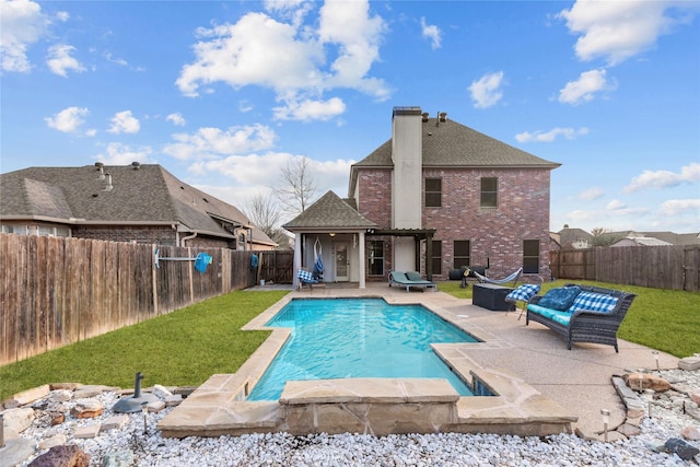 view of pool with a patio, an outdoor hangout area, and a yard