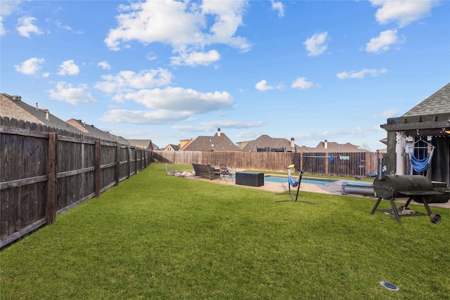 view of yard with a fenced in pool