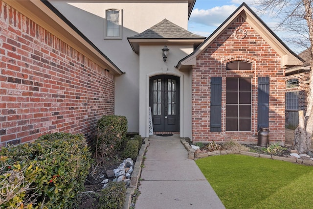 view of exterior entry featuring a yard