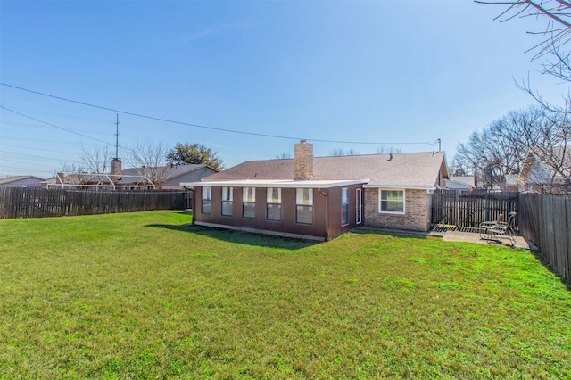 rear view of property featuring a patio area and a lawn
